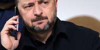 O presidente da Ucr&acirc;nia, Volodymyr Zelensky, falando ao telefone celular  Foto: AFP via Getty Images / BBC News Brasil