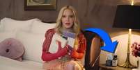 Madonna em sua cama e, na mesa, o frasco do óleo usado contra dores pelo corpo  Foto: Reprodução/YouTube