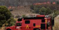 Um ve&iacute;culo da Unidade de Emerg&ecirc;ncia Militar atua enquanto um inc&ecirc;ndio florestal se alastra em Alfajir, perto de Almeria, no sudeste da Espanha, na sexta-feira, 10 de julho de 2026.  Foto: RFI