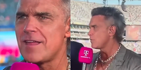 Entrevista que deu origem aos boatos de que Robbie Williams usou coca&iacute;na na final da Copa  Foto: Reprodu&ccedil;&atilde;o/MagentaTV