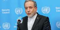 O ministro das Rela&ccedil;&otilde;es Exteriores do Ir&atilde;, Abbas Araghchi, discursa em frente a um p&oacute;dio tendo como fundo o azul da ONU.  Foto: Bloomberg via Getty Images / BBC News Brasil