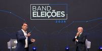 Fl&aacute;vio Bolsonaro e Lula se enfrentam em debate na noite deste domingo, 18  Foto: Reprodu&ccedil;&atilde;o/TV Band
