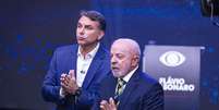 Lula e Flávio Bolsonaro durante debate da Band neste domingo, 18  Foto: BRUNO MOTTA/ENQUADRAR / Estadão