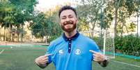Fred Bruno posa com camisa do setor esportivo da Globo  Foto: Reprodu&ccedil;&atilde;o | Globoplay