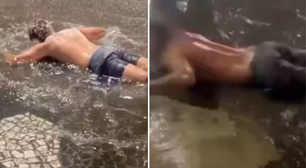 Calouros 'nadam' em poças de água durante trote universitário no litoral de SP