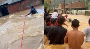 Moradores usam cordas para não serem arrastados e resgatar pessoas em enchente em Paraty (RJ)