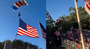 Paraquedista amarrado a bandeira dos EUA fica preso em árvore e cai sobre tenda durante evento