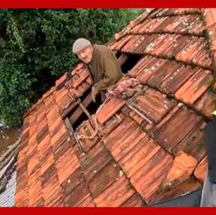 Idoso sorri ao ser resgatado do telhado de casa no Rio Grande do Sul
