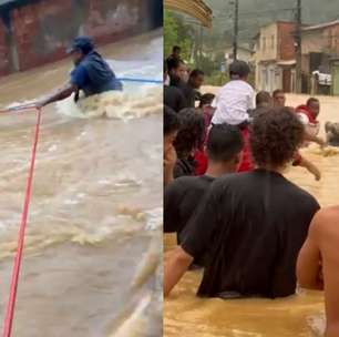 Moradores usam cordas para não serem arrastados e resgatar pessoas em enchente em Paraty (RJ)