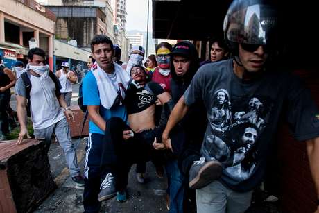 Estudante ferido é socorrido por manifestantes em Caracas Estudante ferido é socorrido por manifestantes em Caracas