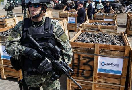 Un policía de frontera custodia cajas de madera llenas de armas confiscadas que están a punto de ser destruidas como parte de un programa gubernamental de control de armas en Campana, al norte de Buenos Aires, el 2 de diciembre de 2016.