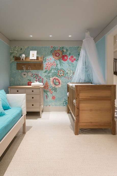 63. Quarto de bebê decorado com papel de parede floral e prateleira de madeira – Foto: Elo7