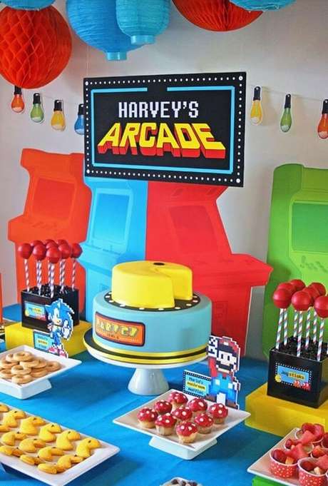 16. Os videogames são ótimos para a decoração de uma festa anos 80. Foto: De Volta ao Retrô 16. Os videogames são ótimos para a decoração de uma festa anos 80. Foto: De Volta ao Retrô