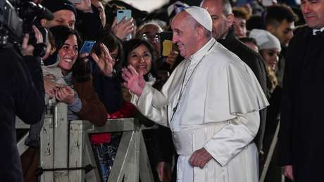 Antes de ser puxado, o papa cumprimentava alegremente fiéis na praça São Pedro, no Vaticano