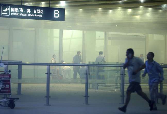 Pessoas correm pelo aeroporto após a explosão