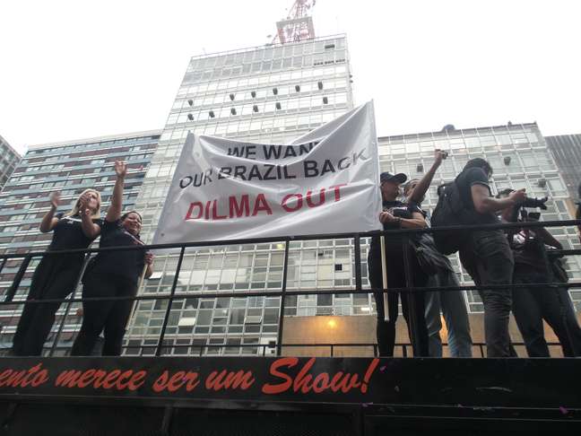 <p>Manifestação do Revoltados On Line segura feixa em inglês que diz "Nós queremos nosso Brasil de volta. Dilma fora"</p>