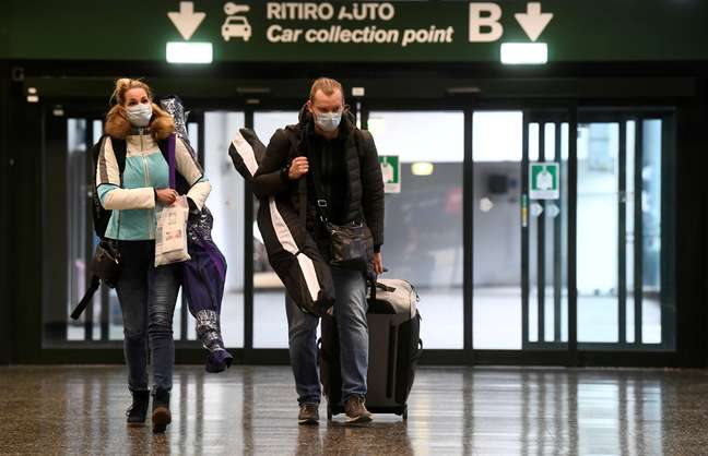 Pessoas usam máscaras protetoras enquanto andam no aeroporto de Malpensa, perto de Milão, Itália. 09/03/2020. REUTERS/Flavio Lo Scalzo