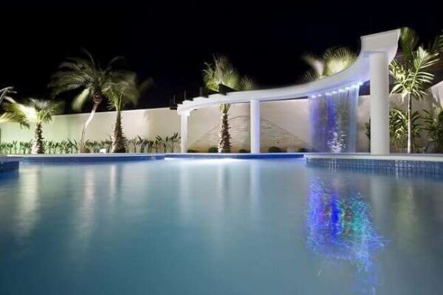30- A cascata para piscina instalada na estrutura de alvenaria com linhas curvas tem iluminação com led. Fonte: Tua Casa