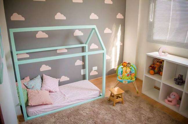 5. Decoração para quarto de bebê montessoriano com tons pasteis no papel de parede e na cama. Projeto por Ana Branco.
