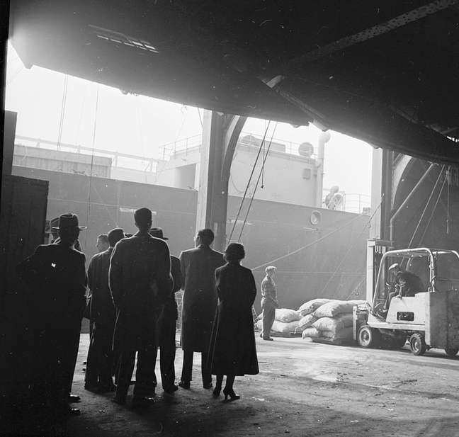Grupo observa estivadores no porto de Nova York em 1955