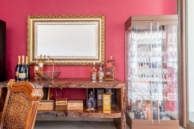 Neste projeto de Isabella Nalon, o aparador ganhou a função de cantinho do bar. Seu estilo rústico ajustou-se com a essência do décor.