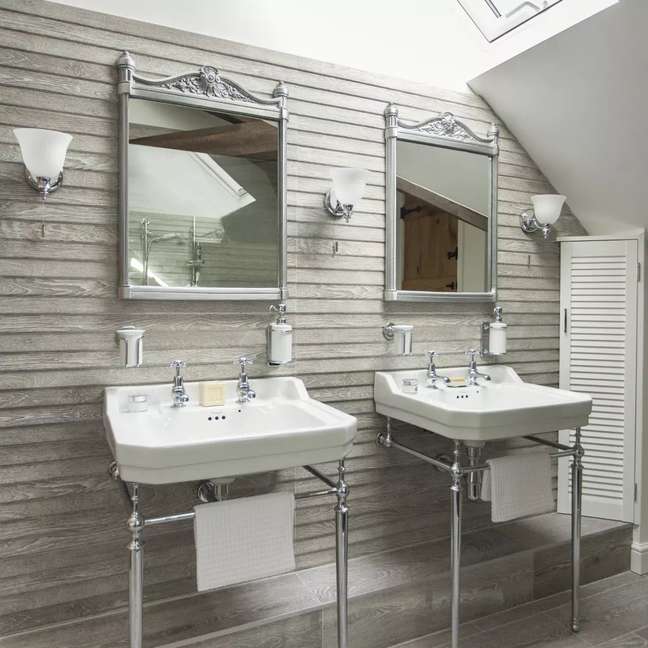 A bathroom with two sinks and two mirrors. A bathroom with two sinks and two mirrors.