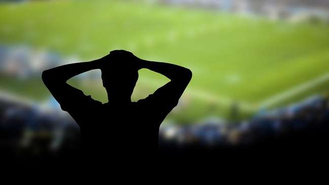Sad man watching the team loses the football match Sad man watching the team loses the football match