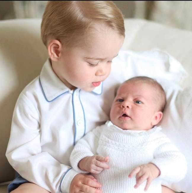 George with his sister Charlotte on his lap George with his sister Charlotte on his lap
