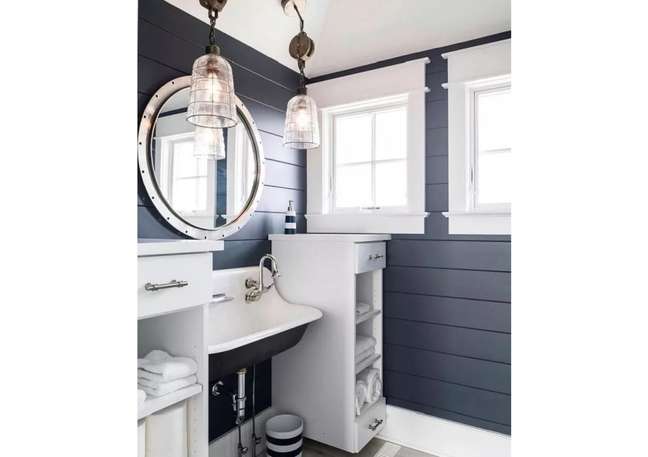 The coast-inspired highlights (like the sconces and the mirror) in this bathroom are very charming. The coast-inspired highlights (like the sconces and the mirror) in this bathroom are very charming.