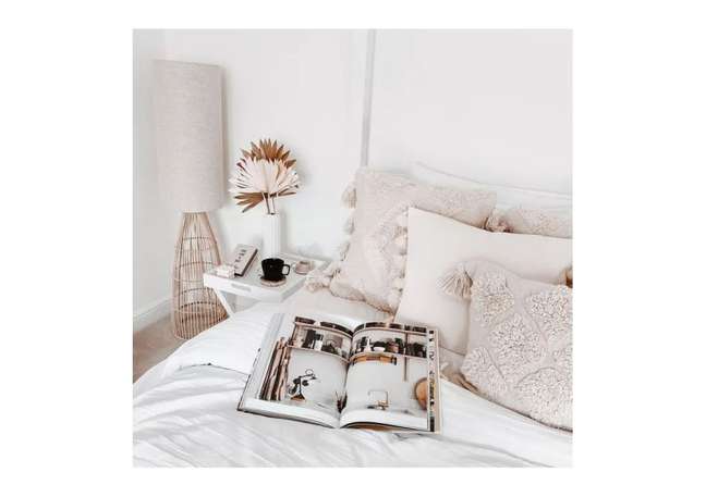 Rattan, faux palm leaves, and muted colors give this room a light and relaxed vibe. Rattan, faux palm leaves, and muted colors give this room a light and relaxed vibe.