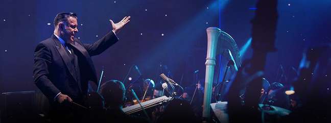 Conductor Adriano Machado in front of the Villa Lobos Symphony Orchestra Conductor Adriano Machado in front of the Villa Lobos Symphony Orchestra