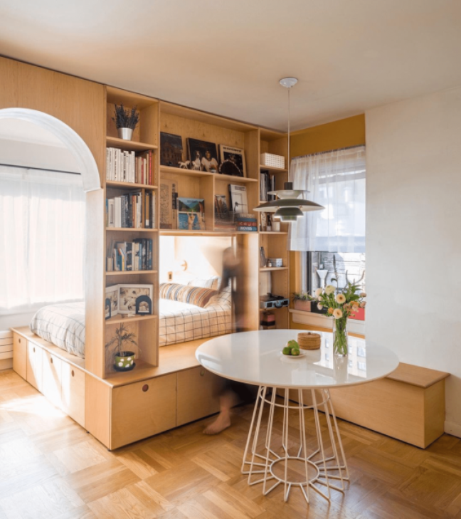 Whether you're working with a studio or a small open layout, a bookcase or modular shelving unit performs a double task: creating a beautiful dining nook while providing additional space. 