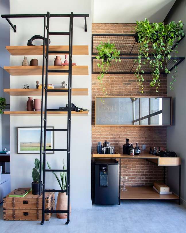 Wooden shelves with decorative items and a blacksmith ladder that helps make everything accessible. Wooden shelves with decorative items and a blacksmith ladder that helps make everything accessible.