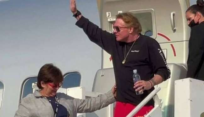 Axl Rose greets fans when he arrives in Manaus for a show