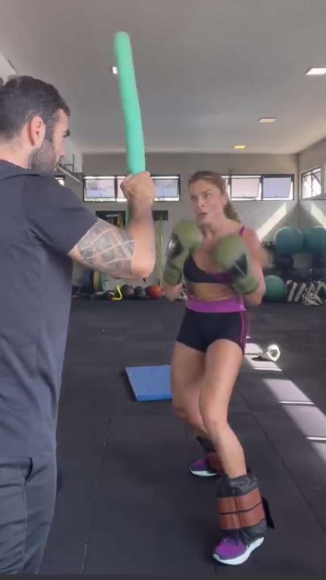 Grazi Massafera wrestling with a personal trainer