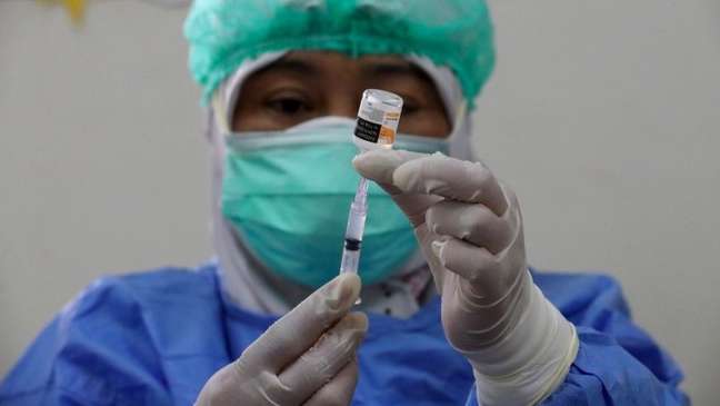 Health worker prepares a dose of CoronaVac vaccine in Indonesia