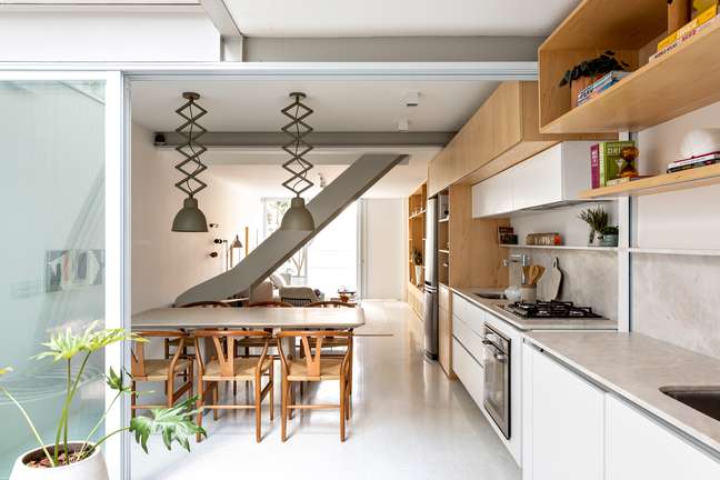 The village house wins the sculptural staircase and the pantograph lamps The village house wins the sculptural staircase and the pantograph lamps