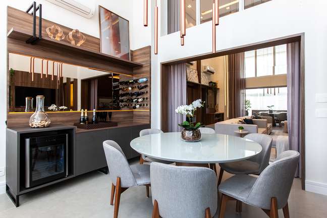 In this double height apartment, the 'dining balcony' has a lacquered round table. In keeping with the palette, the chairs upholstered in light gray fabric. Infinity Space Architecture and Interiors project. In this double height apartment, the 'dining balcony' has a lacquered round table. In keeping with the palette, the chairs upholstered in light gray fabric. Infinity Space Architecture and Interiors project.