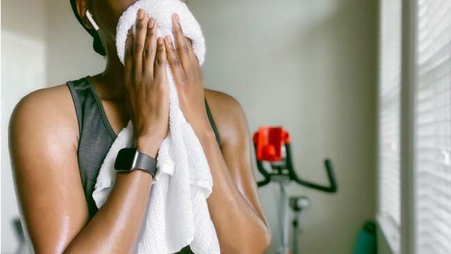 woman wiping her face with a towel