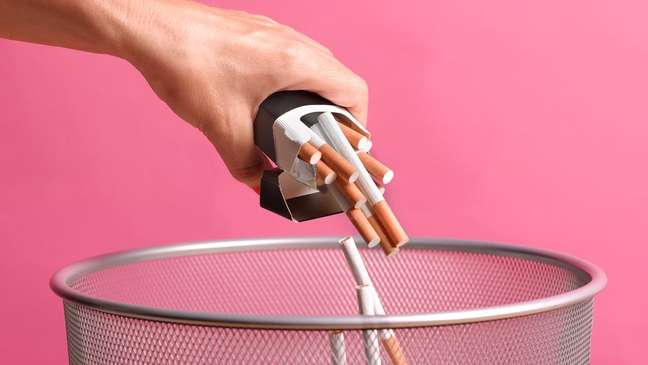 woman throwing out cigarettes