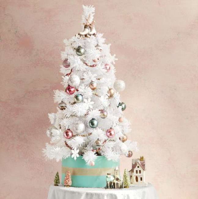 An all-white spruce serves as an eye-catching base for these glittery snowflakes, pastel trinkets, and homey accents. An all-white spruce serves as an eye-catching base for these glittery snowflakes, pastel trinkets, and homey accents.