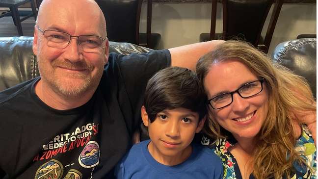Porter Olsen, 11, with his parents Michael and Nicole Porter Olsen, 11, with his parents Michael and Nicole