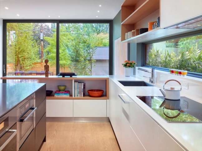 In the photo kitchen with vinyl flooring that imitates wood, worktop and glass openings that allow a view of the outdoor garden.
