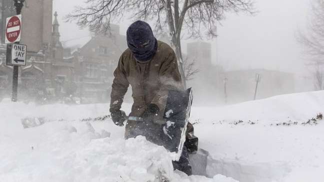 This man in Buffalo, New York struggled to clear a pass in heavy snow This man in Buffalo, New York struggled to clear a pass in heavy snow