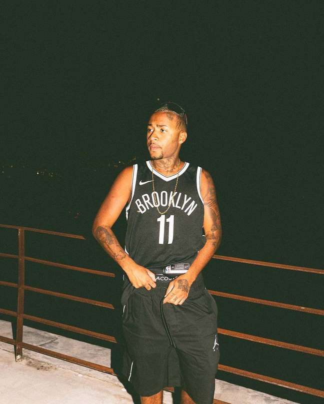 Police approach rapper Orochi in Rio after searching for a weapon that appears in a video on social media