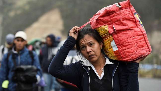 The image of Venezuelan migrants walking along the Pan-American Highway to other South American countries has become iconic. The image of Venezuelan migrants walking along the Pan-American Highway to other South American countries has become iconic.