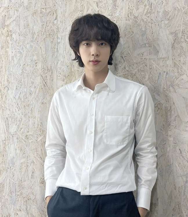 BTS singer Jin greets fans as he begins his military service