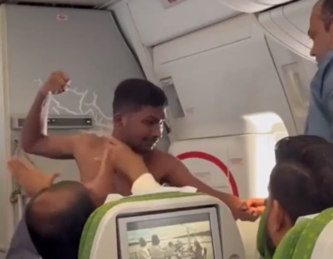 A shirtless passenger punches another on a flight