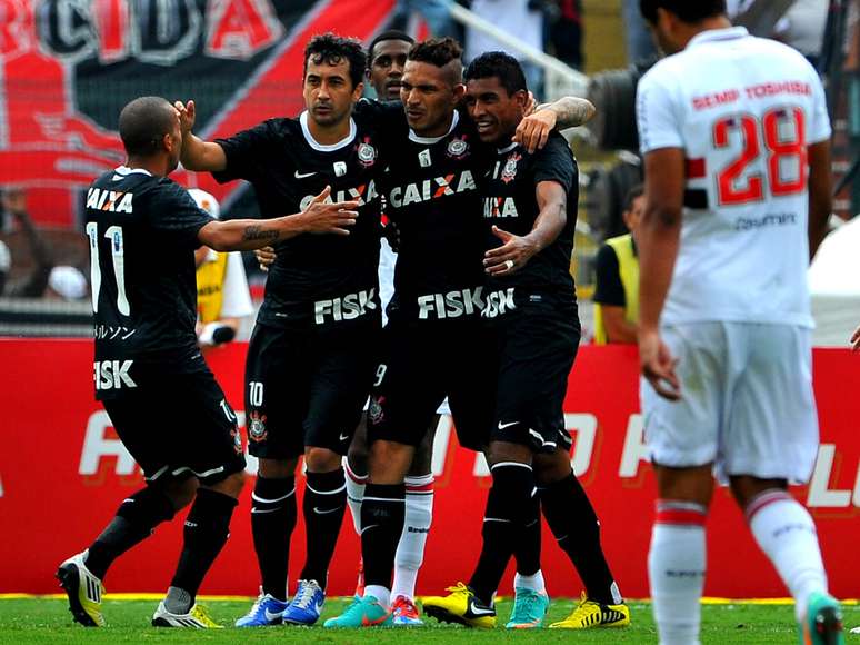 Corintianos se abraçam após gol marcado por Paolo Guerrero