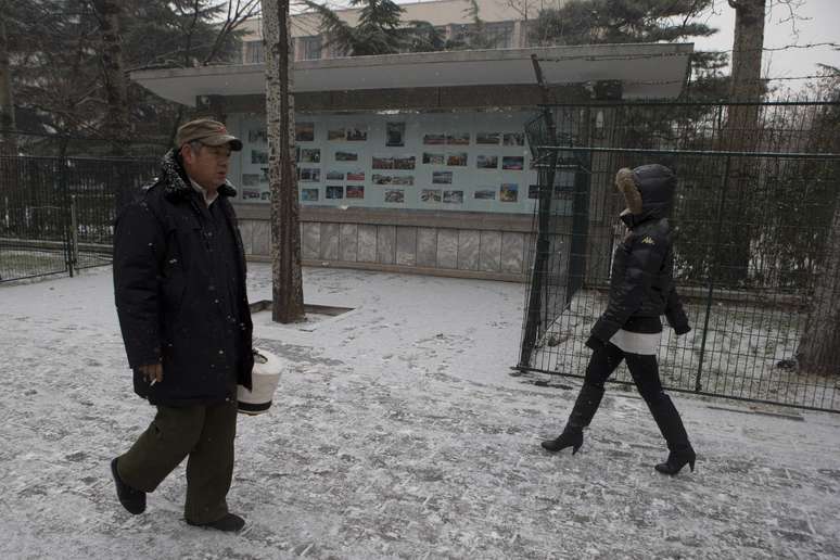 Chineses caminham na frente da embaixada norte-coreana em Pequim